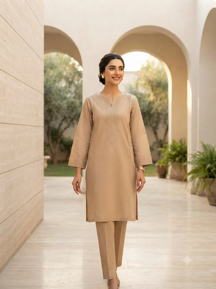 Pakistani woman wearing a premium stitched 2-piece Ready-to-Wear lawn suit by Sahraa in a luxury architectural setting